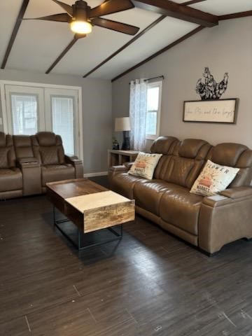 living room featuring ceiling fan, dark hardwood / wood-style floors, and vaulted ceiling with beams