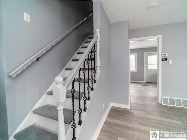 stairs with hardwood / wood-style floors