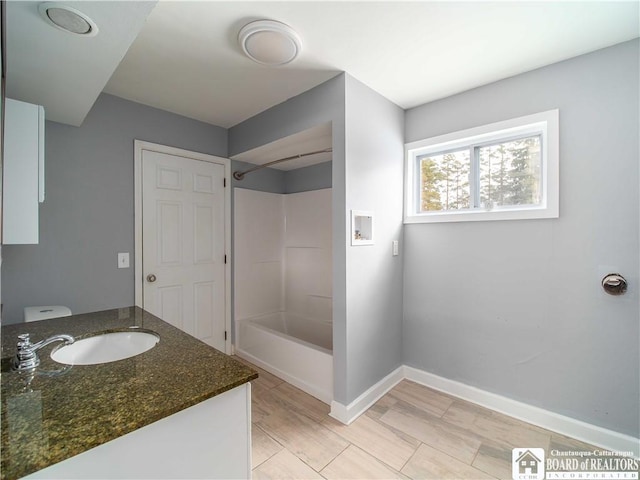 full bathroom featuring vanity, bathtub / shower combination, and toilet