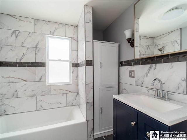 bathroom featuring vanity, tiled shower / bath combo, and tile walls