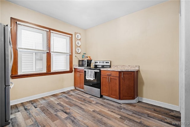 kitchen featuring appliances with stainless steel finishes and wood-type flooring