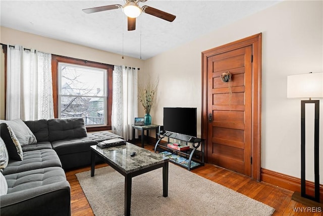 living room featuring ceiling fan and wood-type flooring