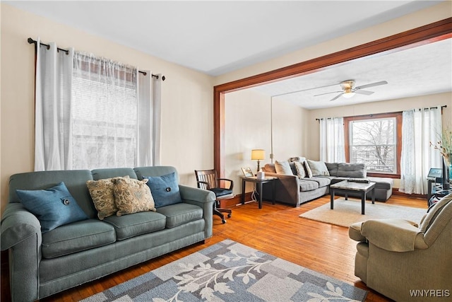 living room featuring ceiling fan and hardwood / wood-style floors