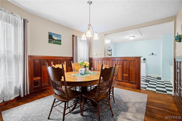 dining area featuring dark hardwood / wood-style floors and a chandelier