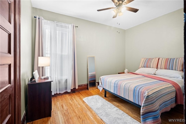 bedroom with ceiling fan and light hardwood / wood-style flooring