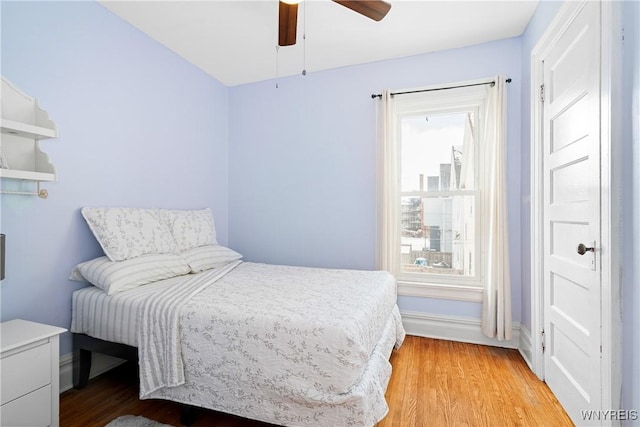 bedroom with ceiling fan and light wood-type flooring