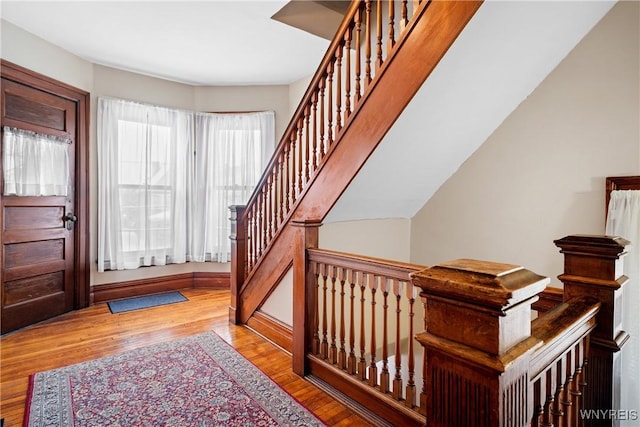 stairs featuring hardwood / wood-style flooring