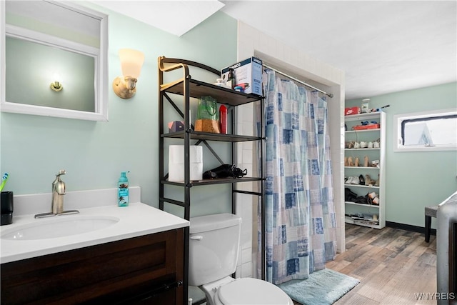 bathroom featuring vanity, hardwood / wood-style floors, a shower with curtain, and toilet