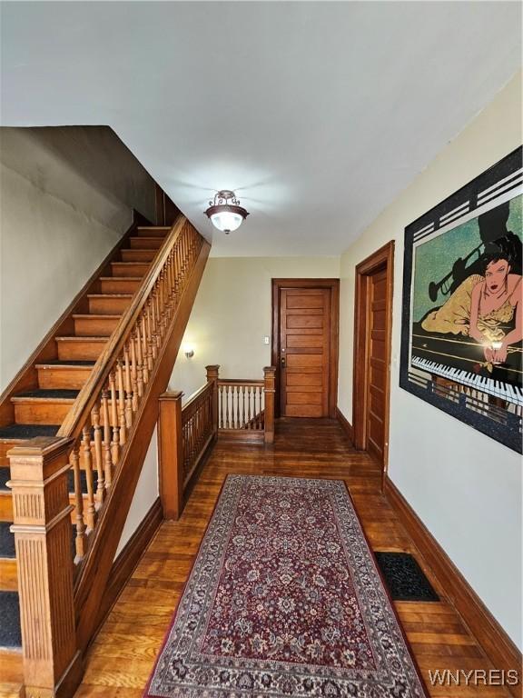 hallway with dark hardwood / wood-style flooring