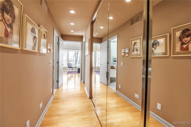 hall with light hardwood / wood-style floors