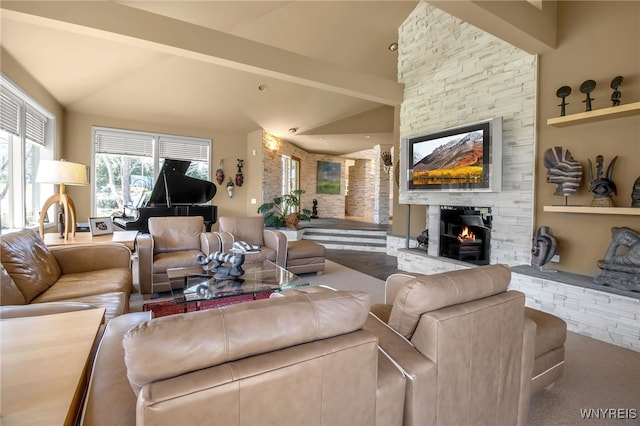 living room featuring vaulted ceiling with beams and a fireplace