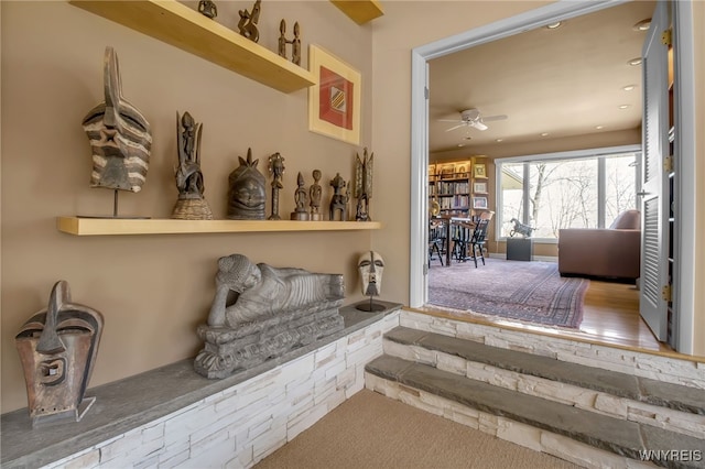 interior space with ceiling fan