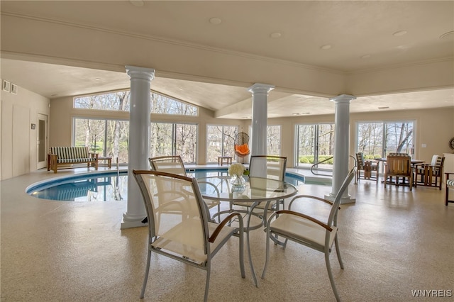 dining area featuring vaulted ceiling, ornamental molding, and ornate columns