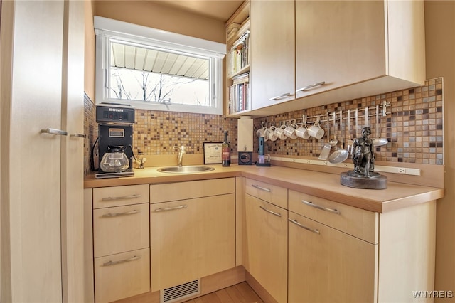 kitchen featuring tasteful backsplash and sink