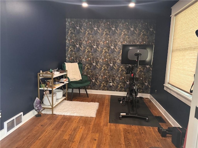 exercise room with wood-type flooring