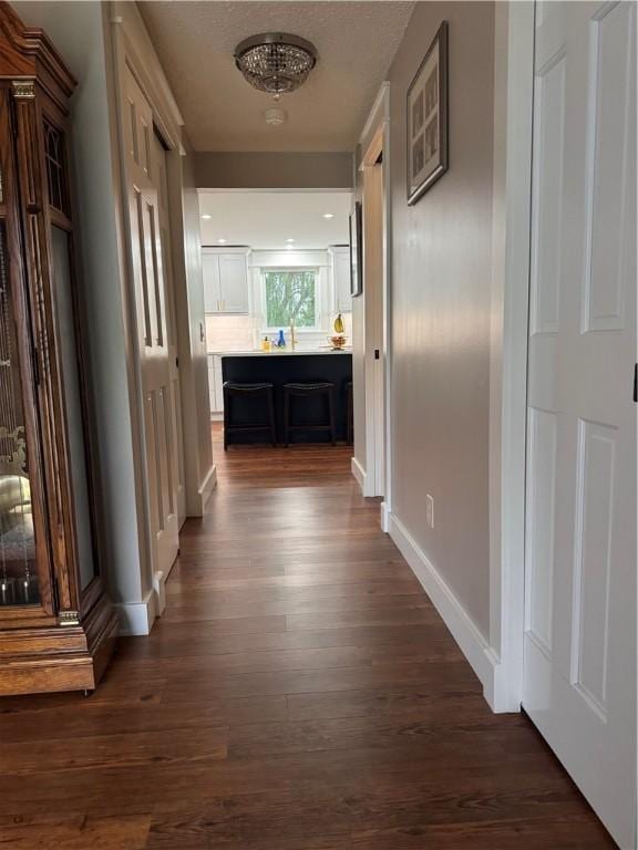 hallway with dark hardwood / wood-style floors