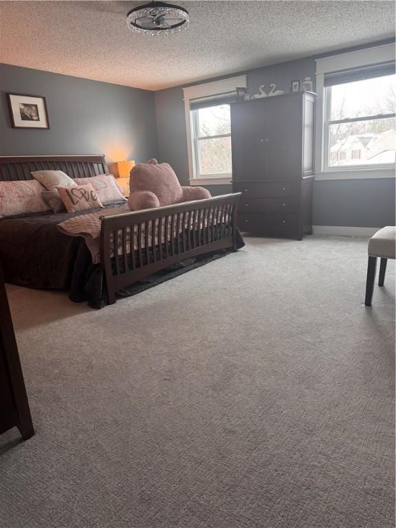 carpeted bedroom with a textured ceiling