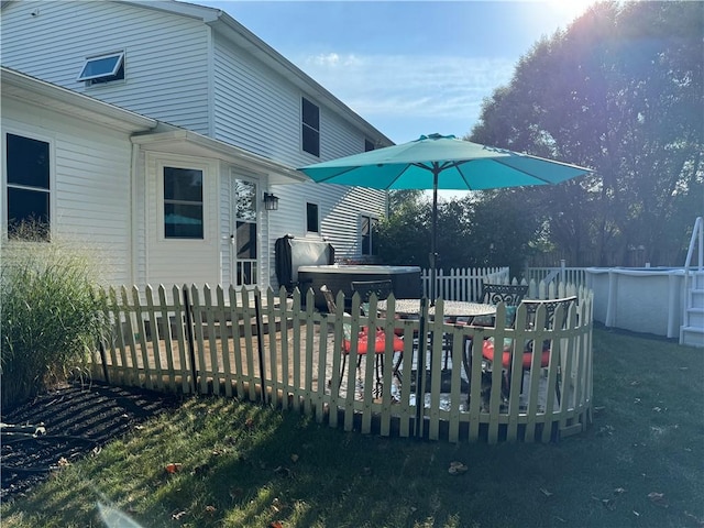 exterior space featuring area for grilling and a pool with hot tub