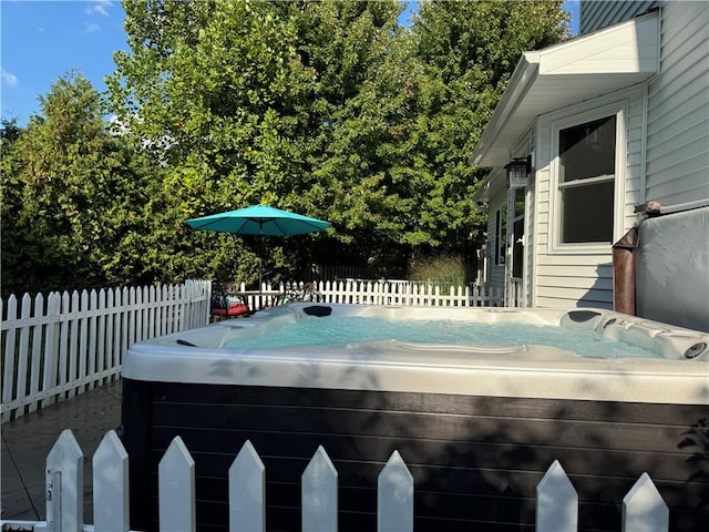 view of swimming pool with a hot tub