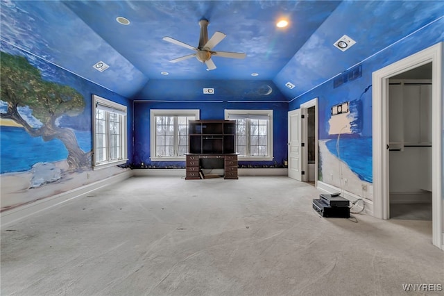 unfurnished living room featuring lofted ceiling, ceiling fan, and carpet flooring