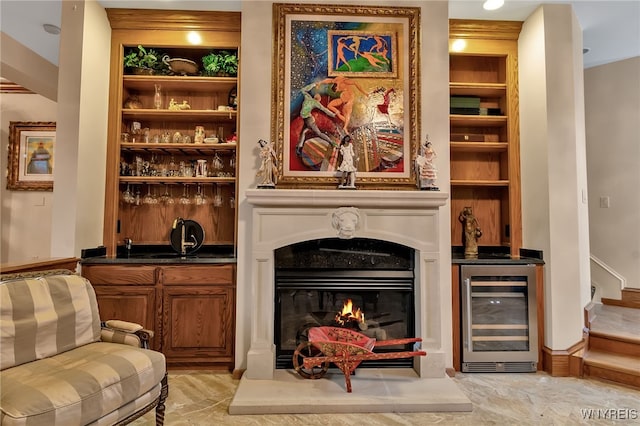 living room featuring built in shelves, bar area, and beverage cooler