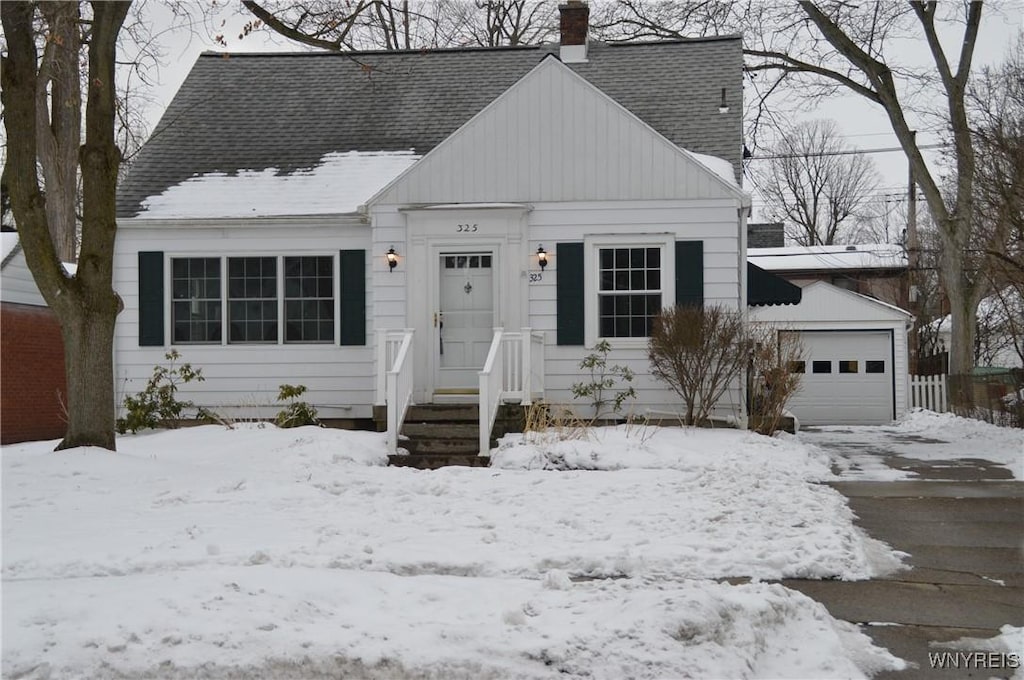 cape cod home with a garage