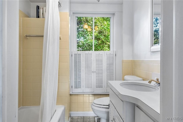 full bathroom with vanity, tile walls, shower / bath combination with curtain, and toilet