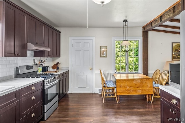 kitchen with dark wood-type flooring, stainless steel range with gas stovetop, decorative backsplash, and decorative light fixtures