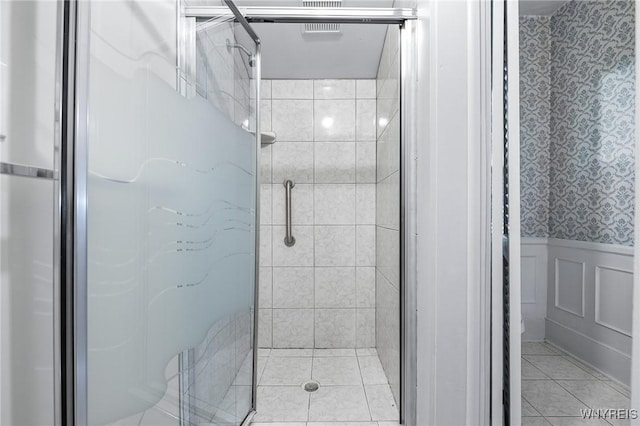 bathroom with tile patterned floors and a shower with shower door