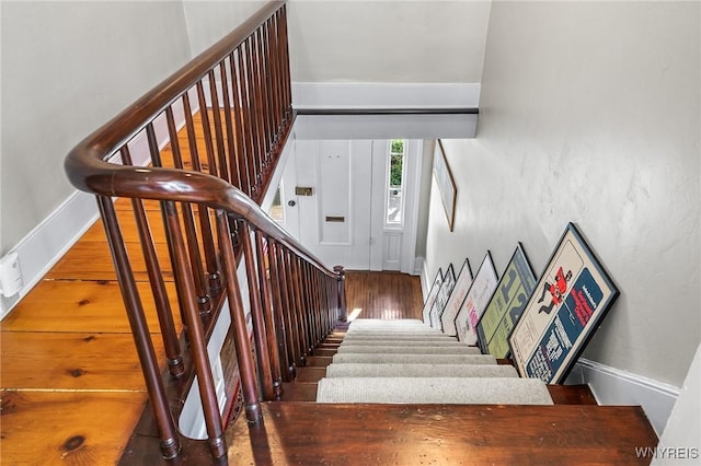 stairs with hardwood / wood-style flooring