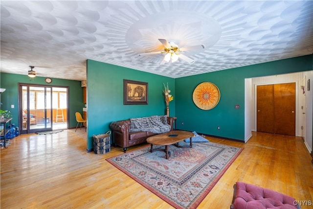 living room with hardwood / wood-style floors and ceiling fan