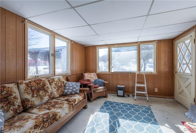 sunroom featuring a wealth of natural light and a drop ceiling