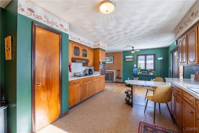 kitchen featuring ceiling fan, stainless steel gas cooktop, and wall oven