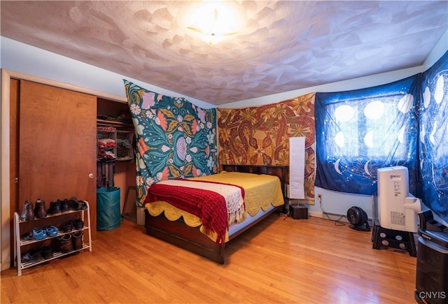 bedroom featuring hardwood / wood-style floors and a closet