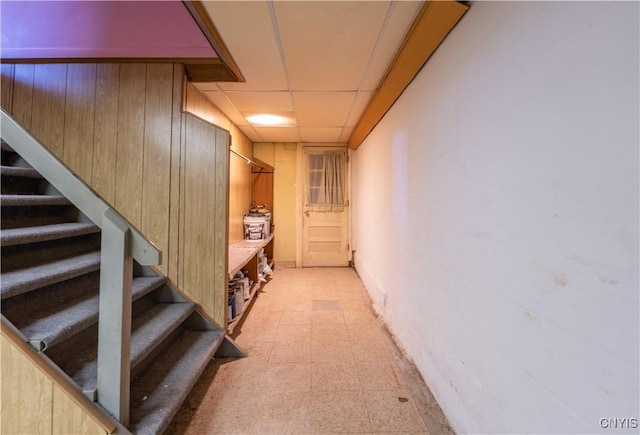 stairs featuring a paneled ceiling