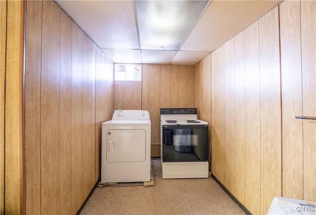 laundry area featuring wood walls