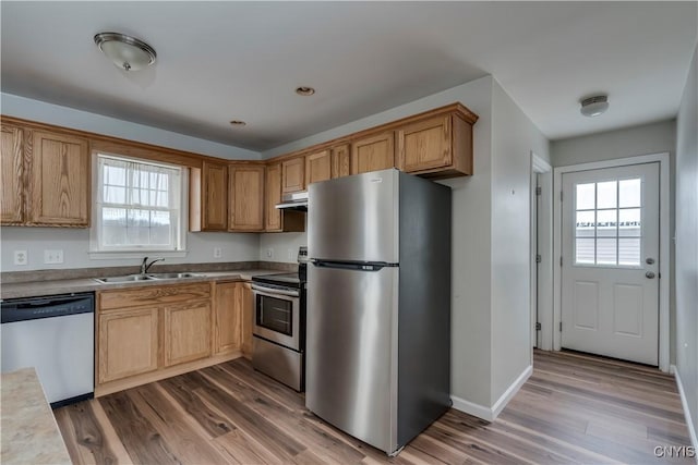 17200 Evans Rd, Hounsfield, NY 13634 - kitchen with under cabinet range hood, dark wood-style flooring, a healthy amount of sunlight, and appliances with stainless steel finishes