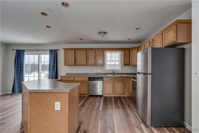 17200 Evans Rd, Hounsfield, NY 13634 - kitchen with stainless steel appliances, a sink, a kitchen island, light countertops, and light wood-type flooring
