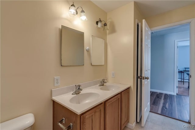 17200 Evans Rd, Hounsfield, NY 13634 - bathroom featuring double vanity, toilet, and a sink