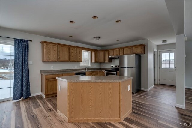 17200 Evans Rd, Hounsfield, NY 13634 - kitchen with baseboards, light wood finished floors, a sink, a kitchen island, and stainless steel appliances