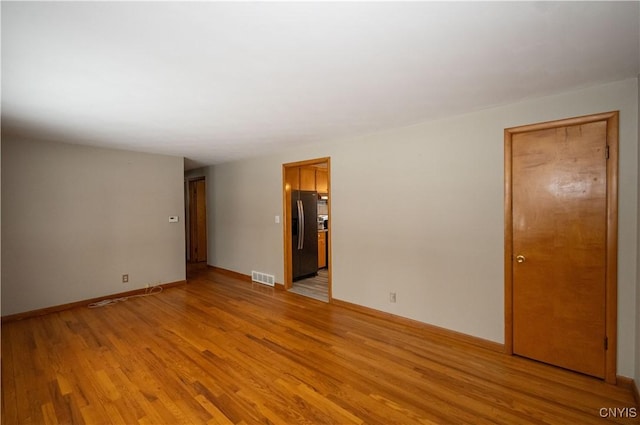 unfurnished room with light hardwood / wood-style floors