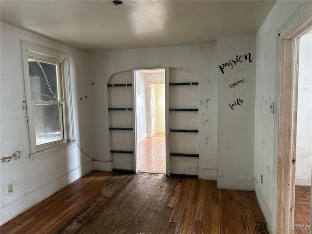 unfurnished room with dark wood-type flooring