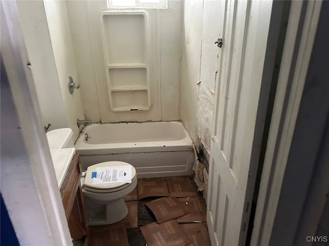 bathroom featuring vanity, parquet flooring, and toilet