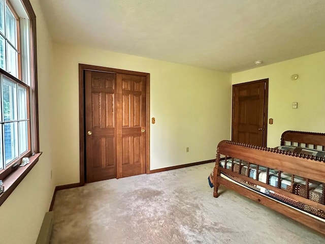 bedroom featuring multiple windows and carpet flooring