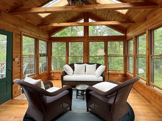 sunroom / solarium with plenty of natural light and lofted ceiling with skylight