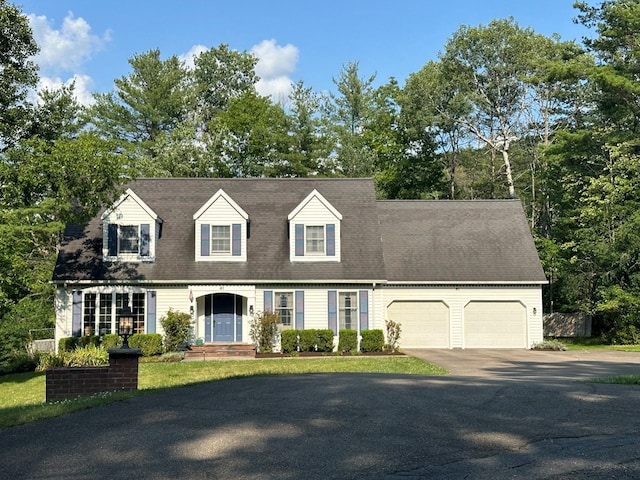 cape cod-style house featuring a garage