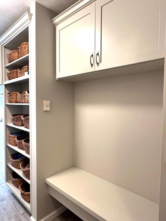 mudroom with a textured ceiling and wood-type flooring