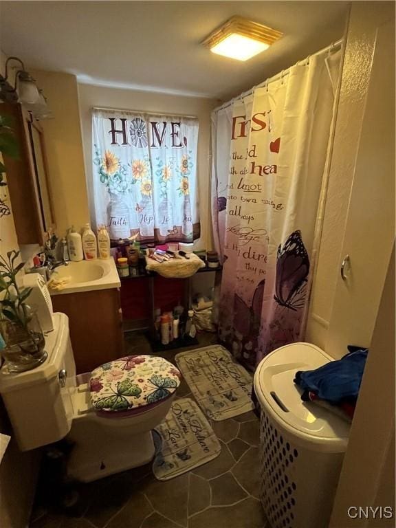 bathroom with vanity, curtained shower, tile patterned floors, and toilet