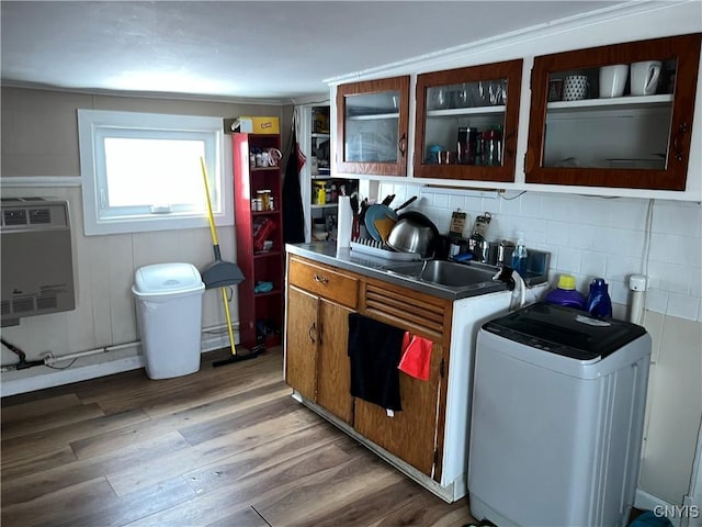 kitchen featuring hardwood / wood-style flooring, sink, and backsplash