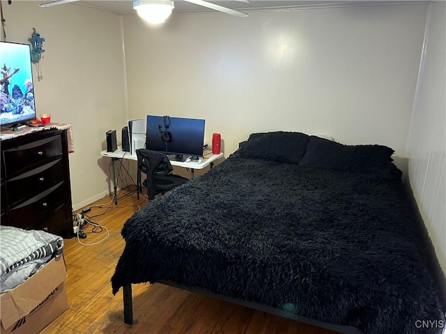 bedroom with hardwood / wood-style floors and ceiling fan